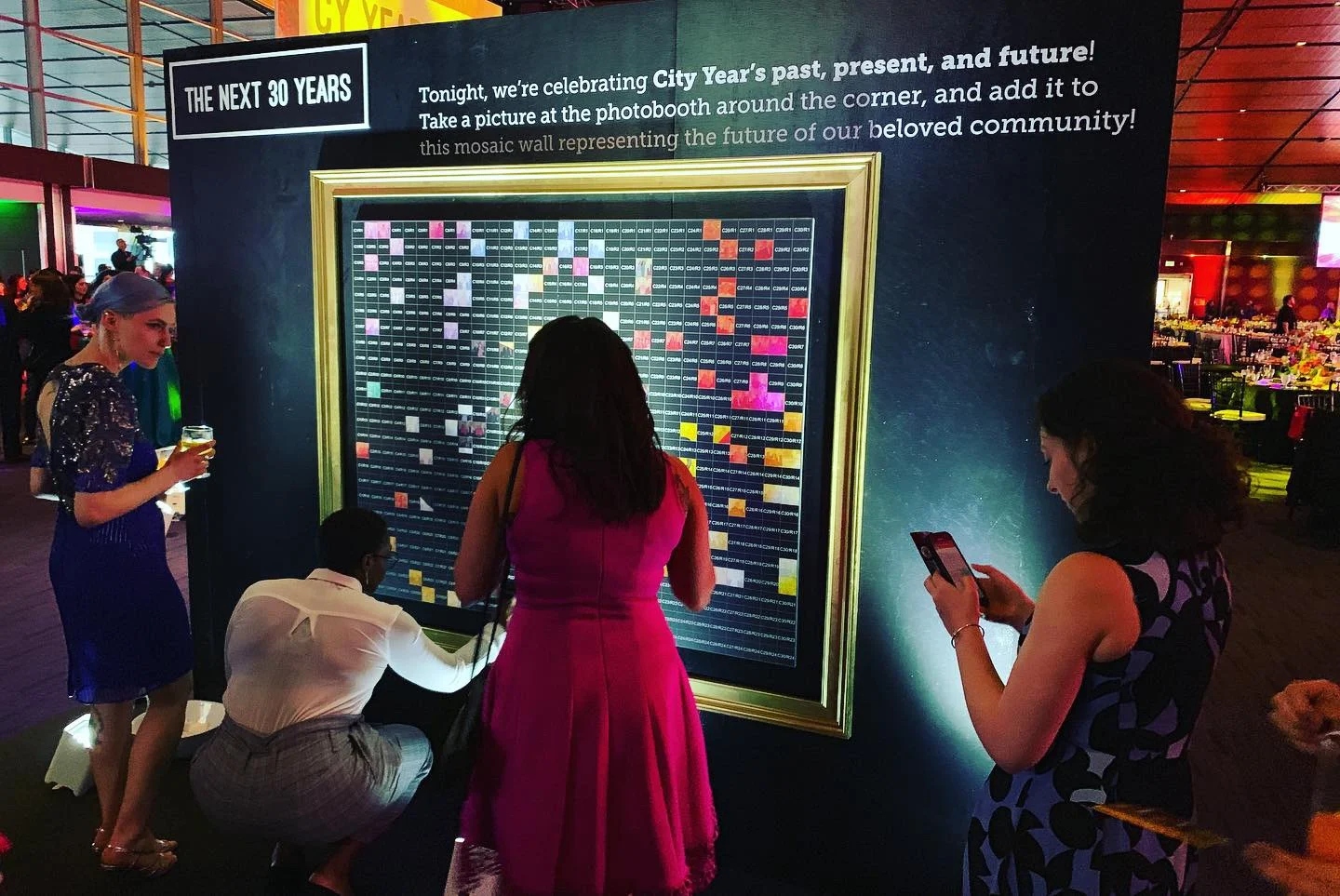 people on photo mosaic wall event